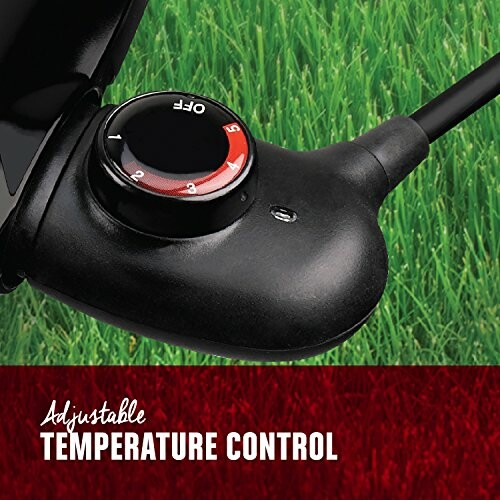 Adjustable temperature control knob on a green lawn