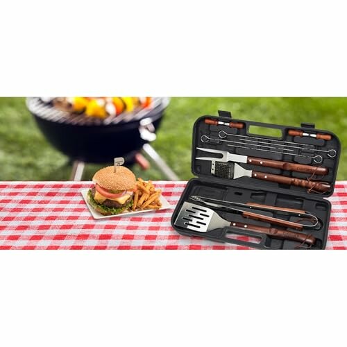 Barbecue tool set on table with burger and fries in the background