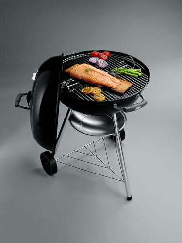 Charcoal grill with salmon and vegetables