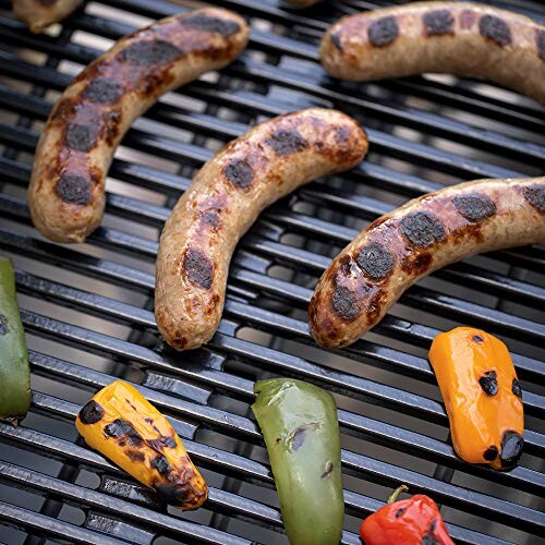 Grilled sausages and peppers on a barbecue grill.